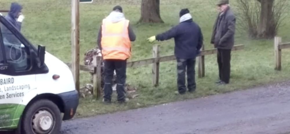 a work crew pointing at the snowman