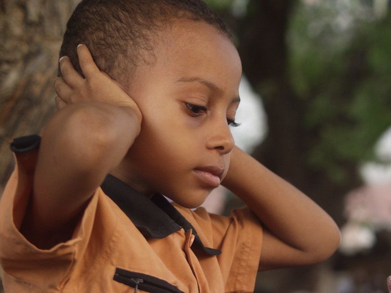 Kid covering ears