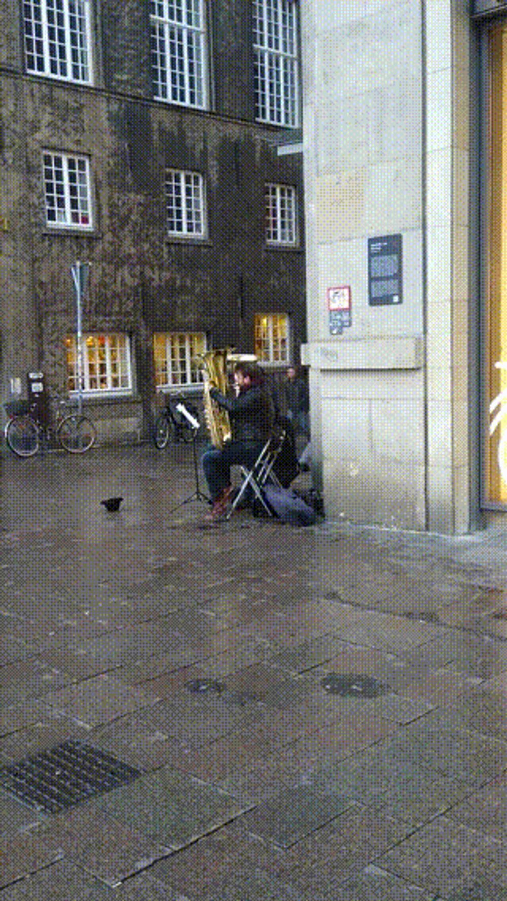 Another image of the same street musician playing